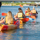 group of people kayaking on a lake